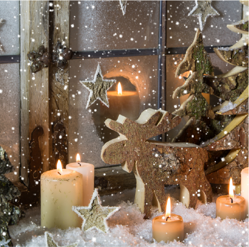 Stimmungsvolle Dekoration mit einem Rentier aus Holz, Bäumen aus Holz und Kunschtschnee